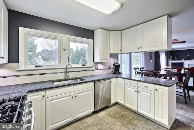 kitchen with white cabinetry, sink, a healthy amount of sunlight, stainless steel appliances, and kitchen peninsula