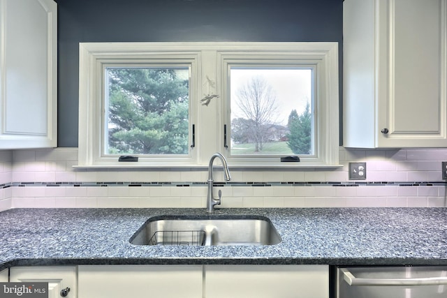 kitchen with white cabinets, dishwasher, sink, and tasteful backsplash