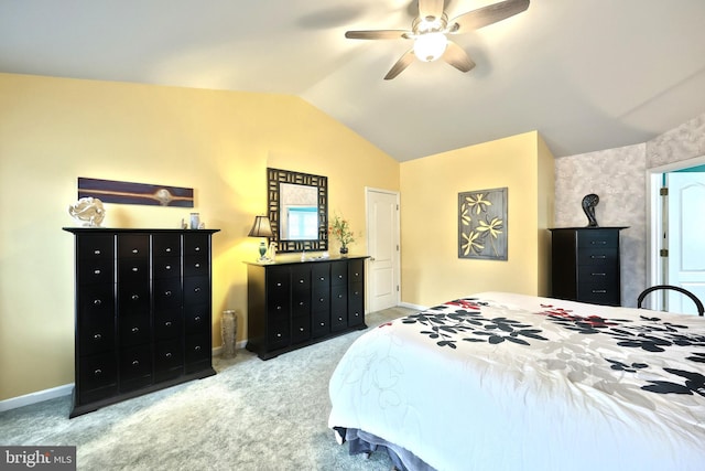 carpeted bedroom featuring vaulted ceiling and ceiling fan