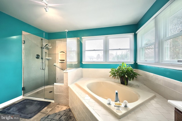 bathroom with tile patterned floors and separate shower and tub