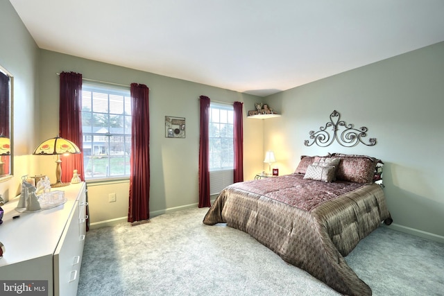 carpeted bedroom featuring multiple windows