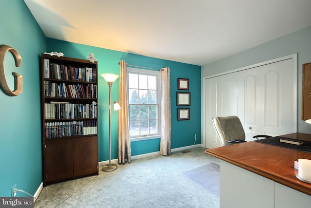 unfurnished office featuring light colored carpet