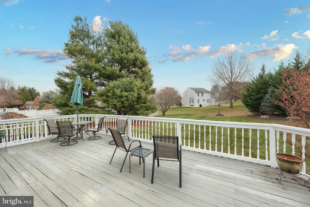 wooden terrace featuring a yard