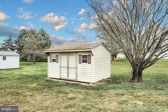 view of outdoor structure with a lawn