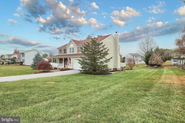 view of front of property with a porch, a garage, and a front lawn