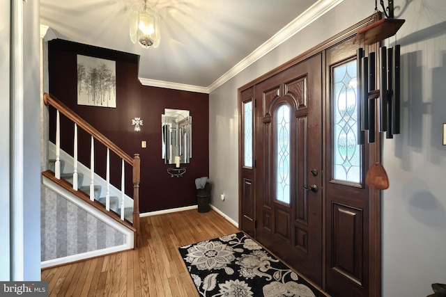 entrance foyer featuring hardwood / wood-style floors and crown molding