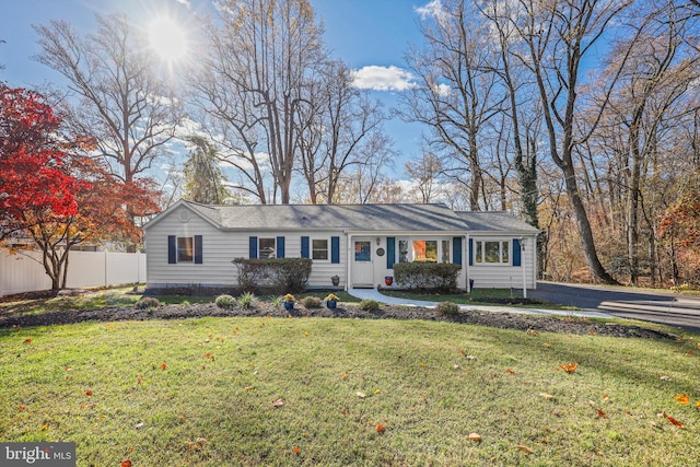 ranch-style home with a front lawn