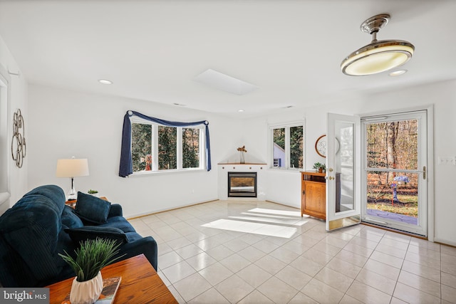 tiled living room with a fireplace and plenty of natural light