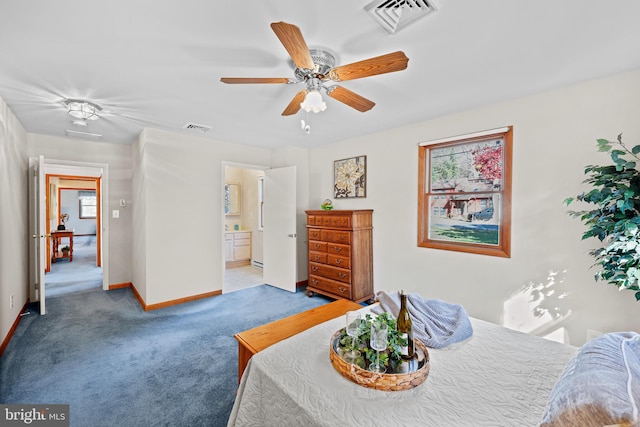 carpeted bedroom featuring ensuite bathroom and ceiling fan