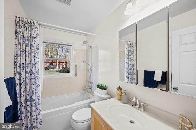 full bathroom featuring shower / bath combo, vanity, and toilet