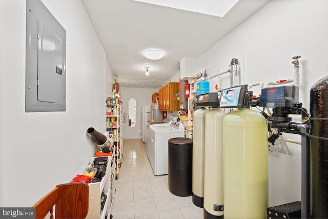 washroom featuring water heater, electric panel, washing machine and clothes dryer, and light tile patterned flooring