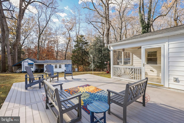 deck with a storage unit and a sunroom