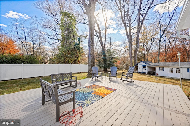 wooden deck featuring a yard