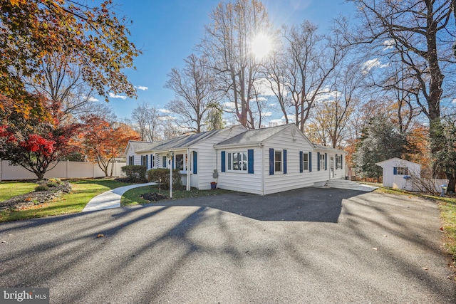 view of front of home featuring a storage unit