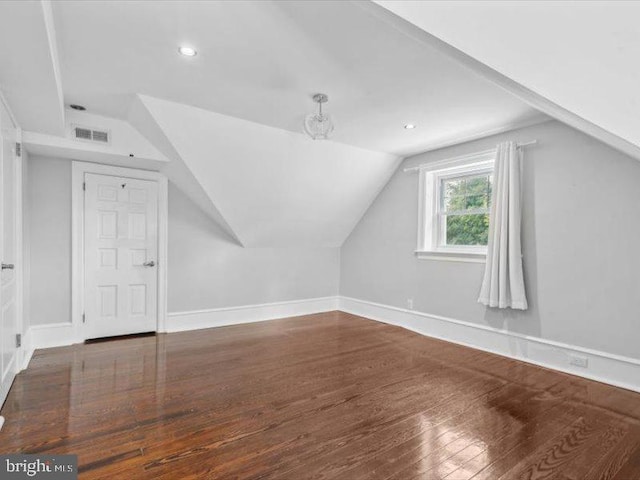 bonus room featuring vaulted ceiling and hardwood / wood-style flooring