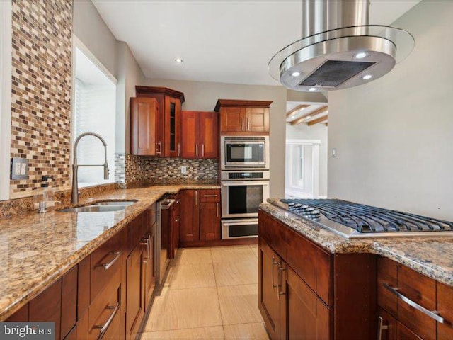 kitchen with sink, stainless steel appliances, tasteful backsplash, light stone counters, and island range hood