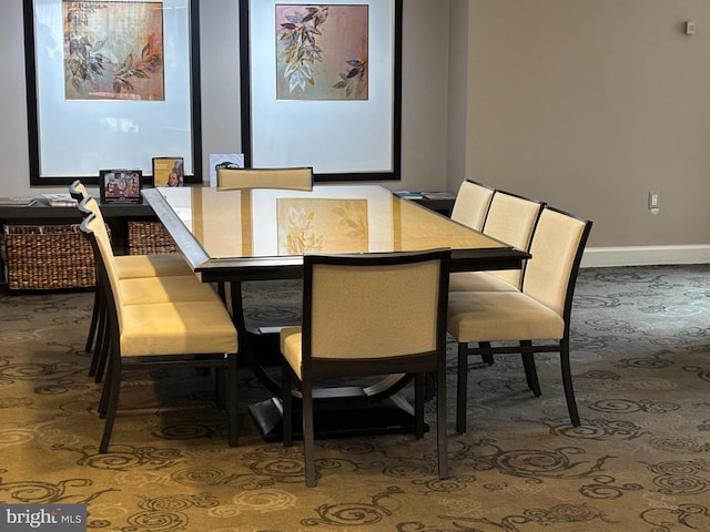 carpeted dining room with baseboards