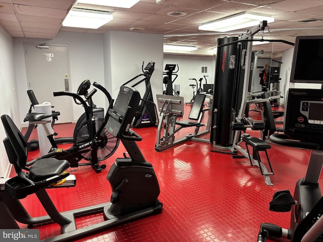 exercise room featuring a drop ceiling