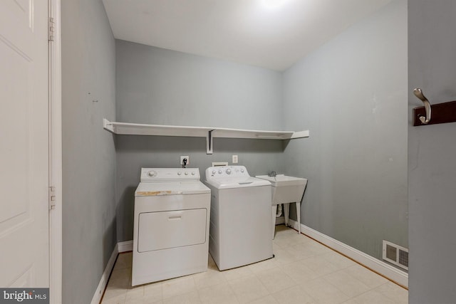 washroom featuring sink and independent washer and dryer