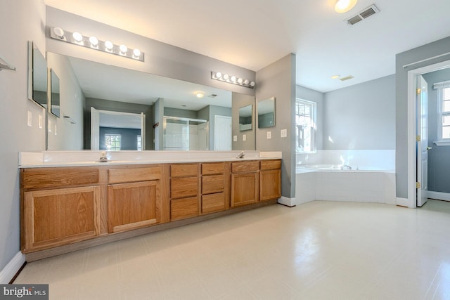 bathroom featuring vanity and separate shower and tub