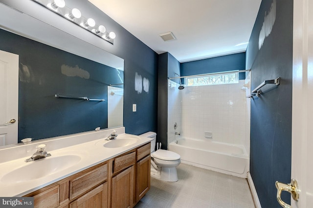 full bathroom with vanity, tiled shower / bath combo, and toilet