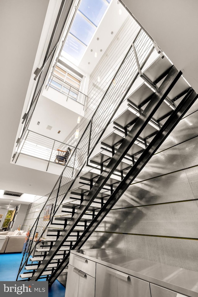 stairway featuring a high ceiling