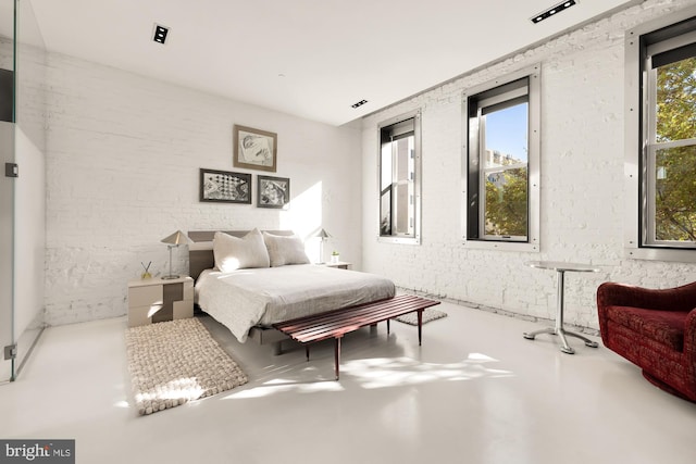 bedroom featuring concrete flooring