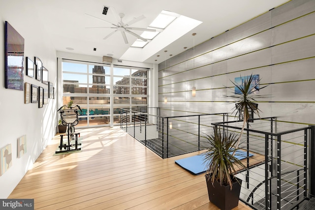 interior space featuring a skylight and hardwood / wood-style flooring