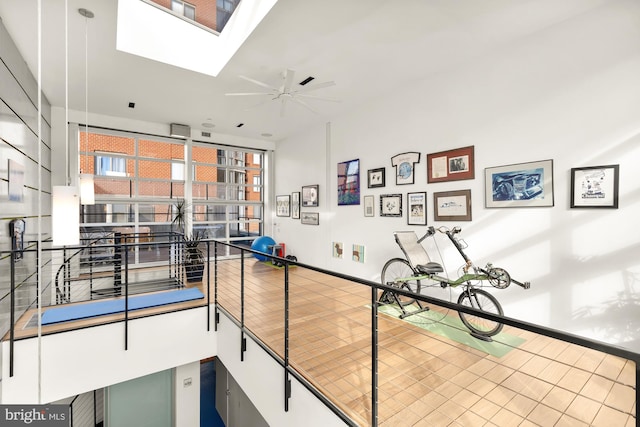 hall featuring wood-type flooring and a wealth of natural light