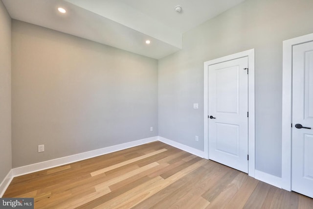 empty room with light hardwood / wood-style flooring