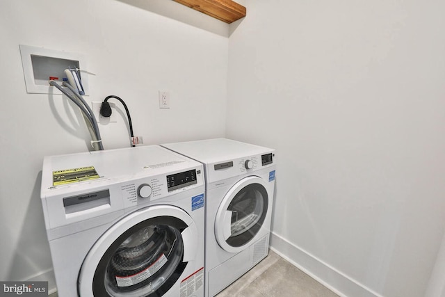 clothes washing area with separate washer and dryer