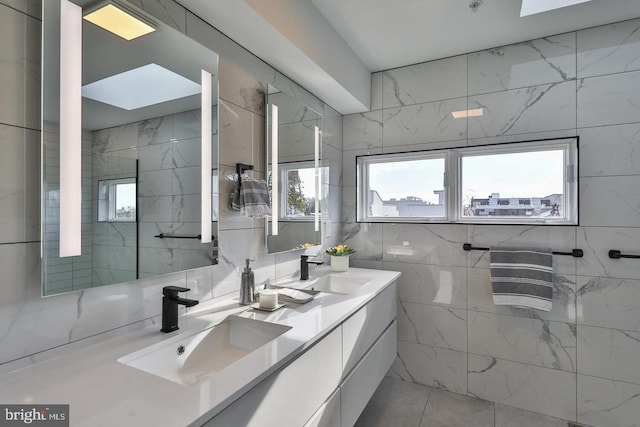 bathroom featuring vanity, tile walls, and tile patterned flooring