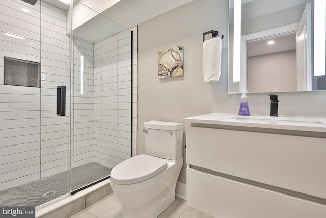 bathroom featuring vanity, a shower with shower door, tile patterned flooring, and toilet