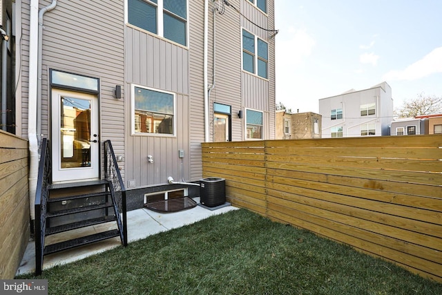 view of yard featuring central AC and a patio