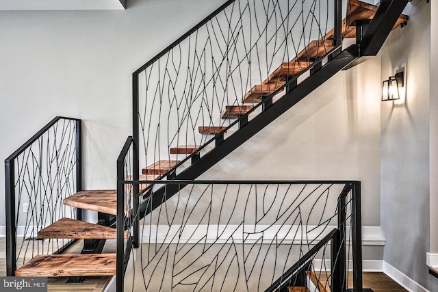 stairs featuring hardwood / wood-style floors