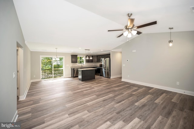 unfurnished living room with lofted ceiling, ceiling fan, sink, and dark hardwood / wood-style flooring