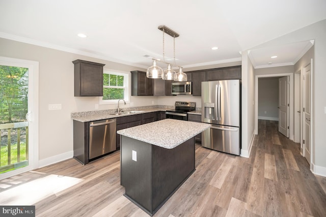 kitchen featuring a kitchen island, sink, dark brown cabinetry, and stainless steel appliances