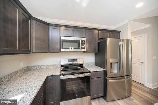 kitchen featuring dark brown cabinets, light stone countertops, appliances with stainless steel finishes, and light hardwood / wood-style flooring