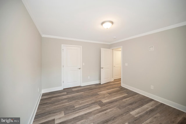 unfurnished bedroom featuring dark wood-type flooring and ornamental molding