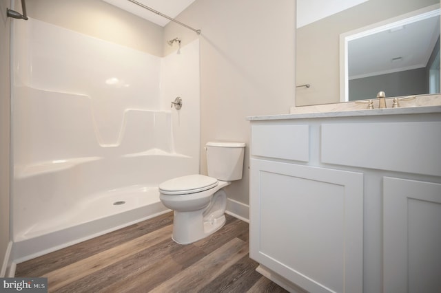 bathroom with a shower, wood-type flooring, vanity, and toilet