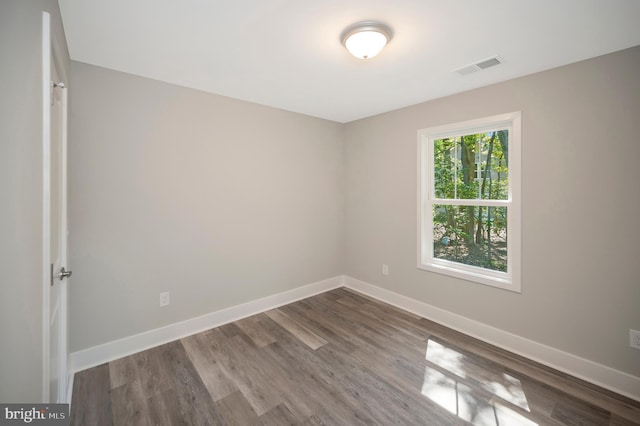 unfurnished room with wood-type flooring