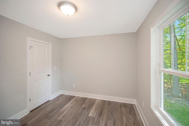 unfurnished room featuring dark hardwood / wood-style floors