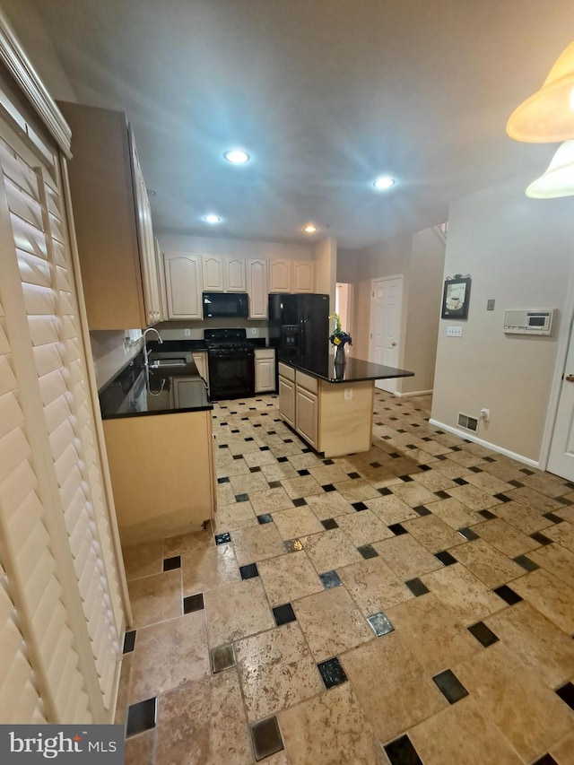 kitchen with a kitchen bar, sink, a kitchen island, and black appliances