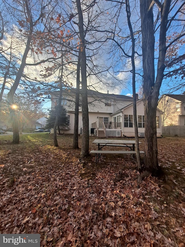 back of property featuring a wooden deck