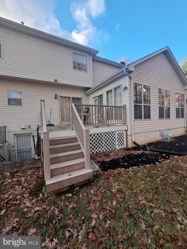 back of house with a deck