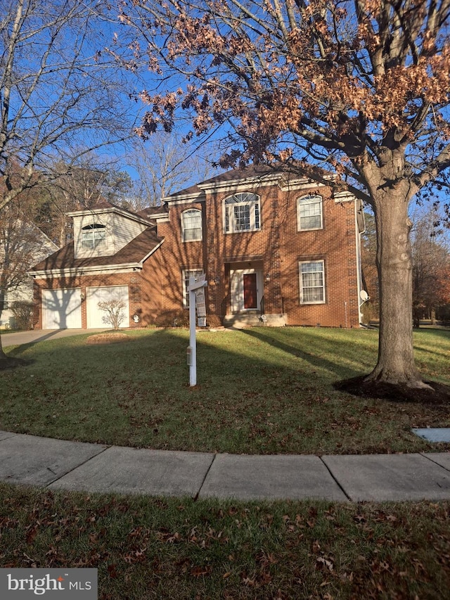 view of front of property with a garage and a front yard