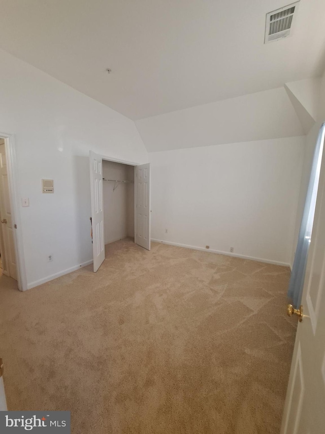 bonus room with light carpet and lofted ceiling