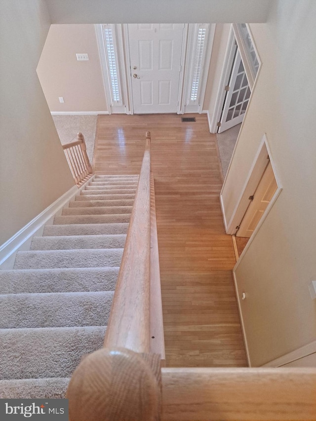 stairs featuring wood-type flooring