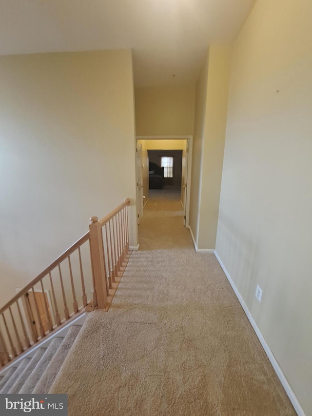 hall with light colored carpet