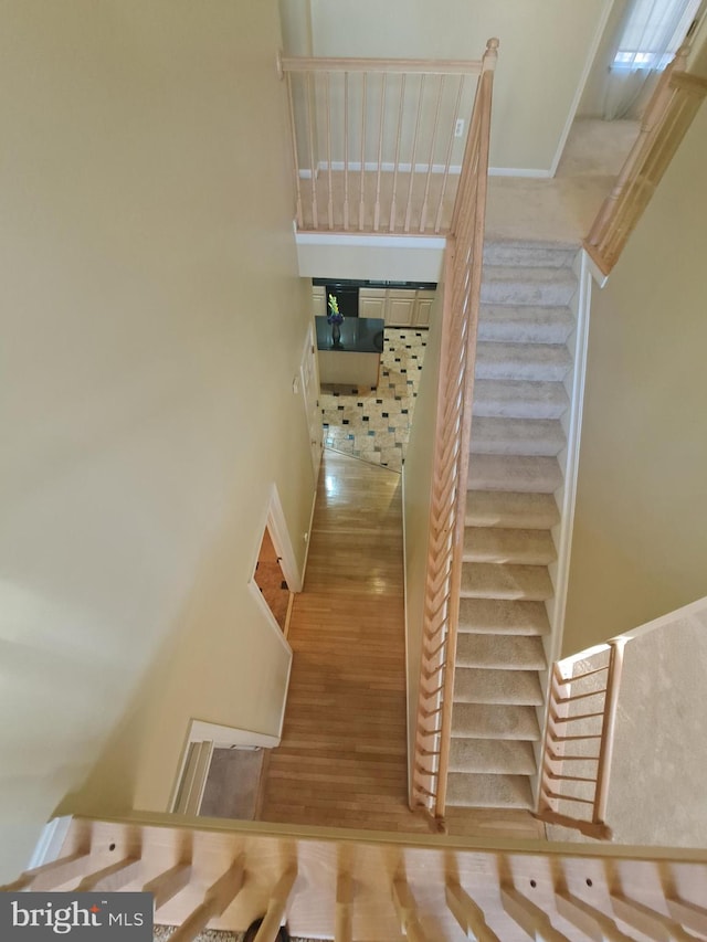 stairway featuring hardwood / wood-style flooring